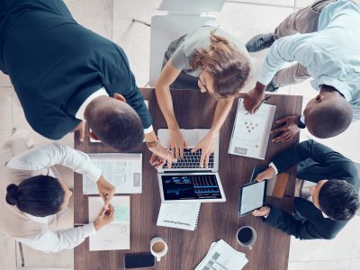 Planning, project management and marketing with business people in meeting for research, strategy and goals with laptop. Growth, analytics and collaboration with employees in corporate office